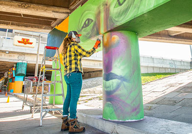 Image of an artist working on a community art project