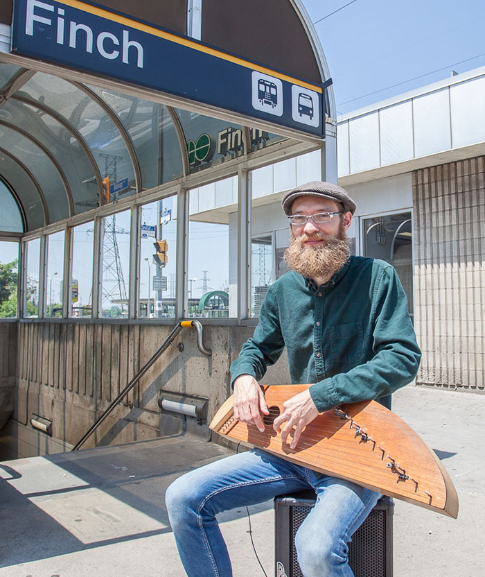 Matti Palonen holding his kantele outside of Finch Station.
