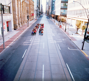 Third image of four, all the drivers and their seats are repositioned into the same space taken up by one streetcar and all streetcar riders are comfortably seated.