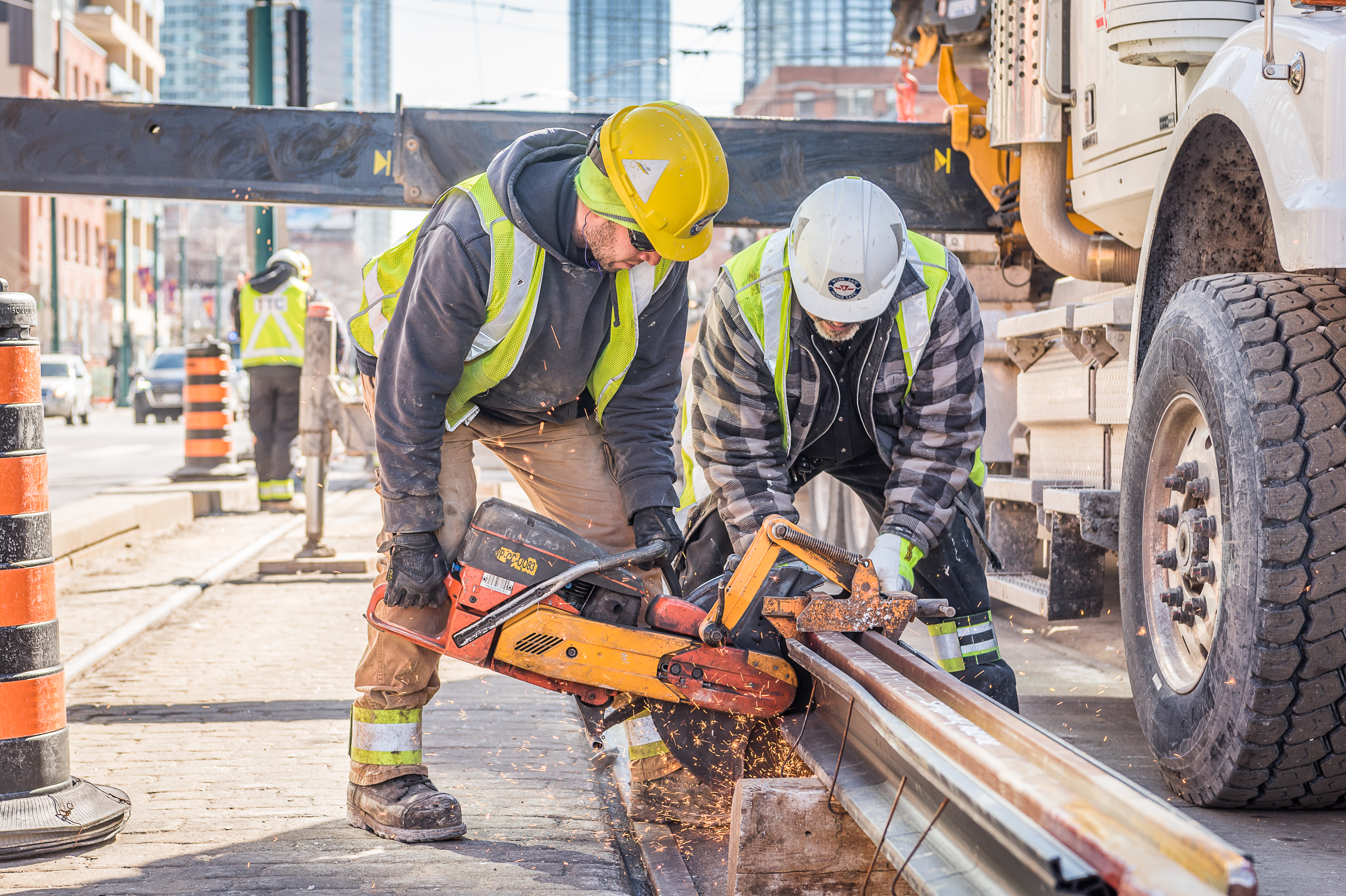 workers cutting rail on a construction site