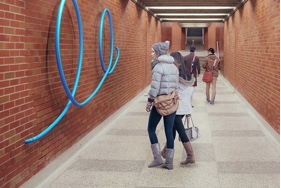 Blue art on subway wall.